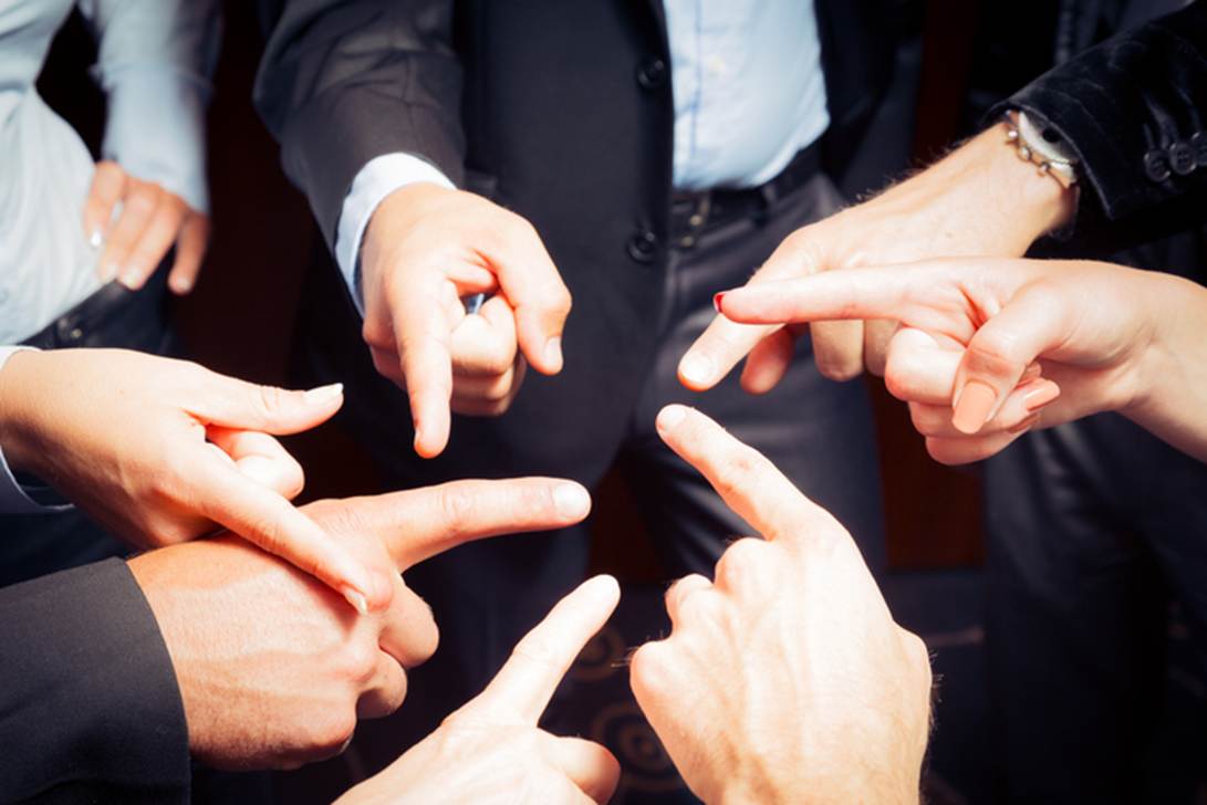 A group of hands pointing at each other

AI-generated content may be incorrect.